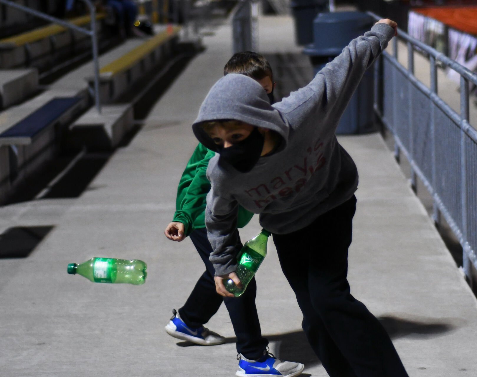 Jack Shimmens and Brock Ralston scrimmage with bottles of soda as a football